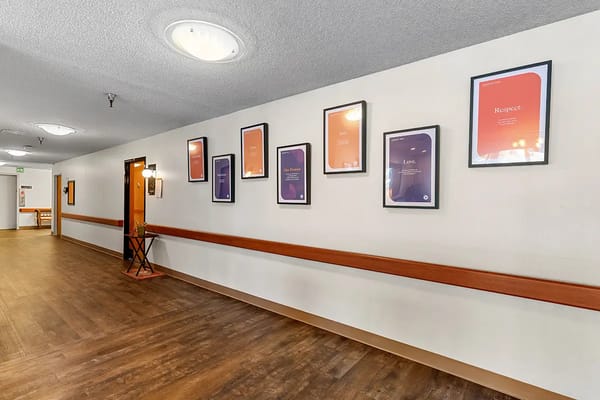 Interior hallway with framed values on the wall