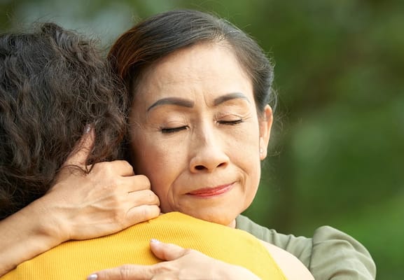 Two women embracing in a caring moment