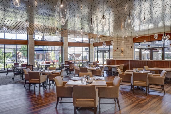 Bright dining room with modern decor and large windows