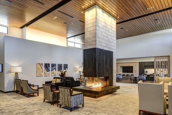 Interior common area with a fireplace and seating