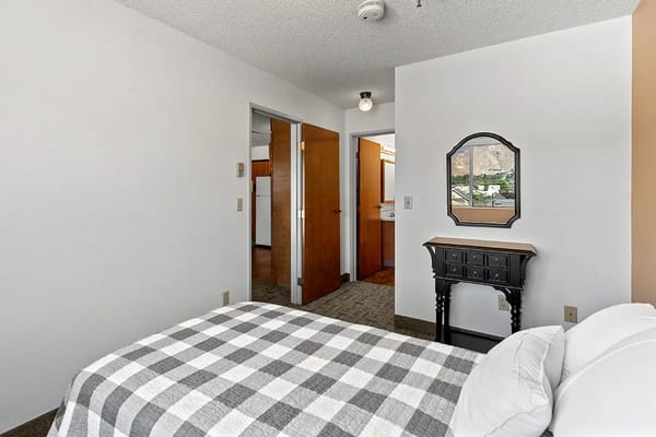 Cozy resident room with a bed and mirror