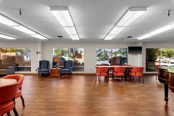 Bright common area with seating and large windows