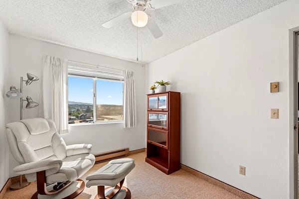 A cozy private resident room with a chair and window