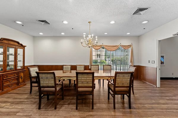 Bright dining area with wooden chairs and table