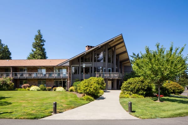 Exterior view of a senior living facility with landscaped gardens