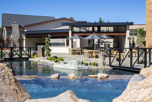 Outdoor area with seating and a serene water feature