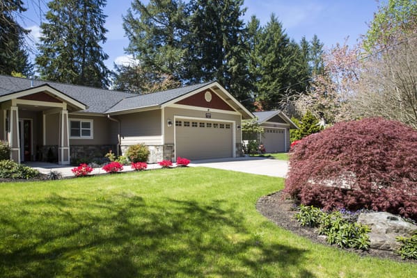 Exterior view of a senior living facility with landscaped garden