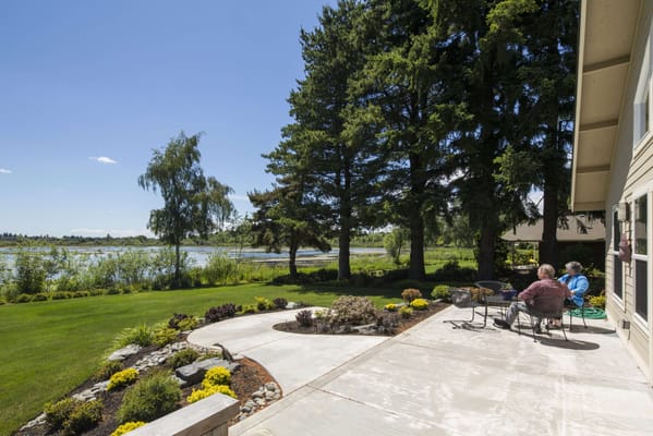 Residents enjoying the outdoor patio by the lake