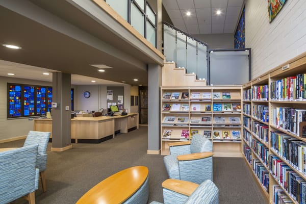 Interior view of a sunny library space with bookshelves