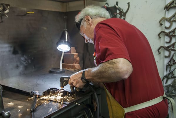 Resident engaged in a woodworking activity at a workbench