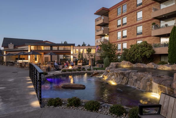 Outdoor gathering area with a pond and residents