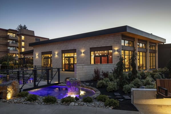 Exterior view of a nursing home with a garden and water feature