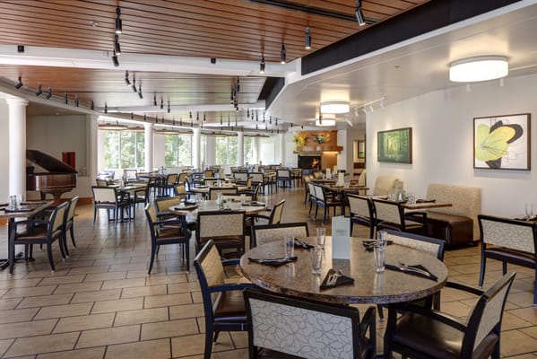 Elegant dining room with tables set for residents