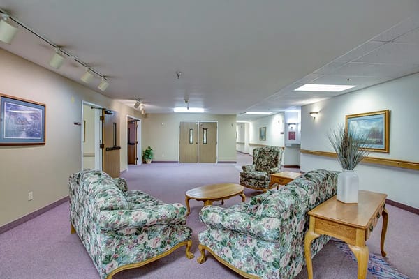 Interior common area with floral couches and tables
