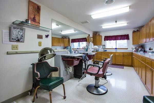 Hair salon area with styling chairs and sinks