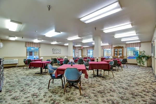 Dining area with tables and chairs set up for residents