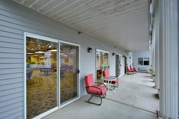Residents relaxing on a patio area outside