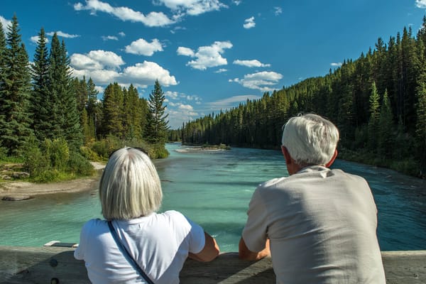 Senior couple enjoying a scenic river view