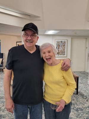 Two residents smiling together in a common area