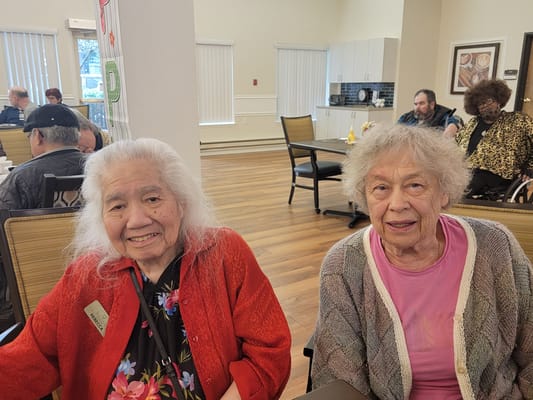 Two residents smiling in a common area