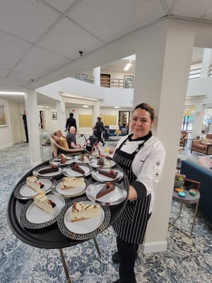 Chef serving desserts in a common area
