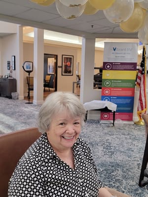 Smiling resident in a common area during celebration
