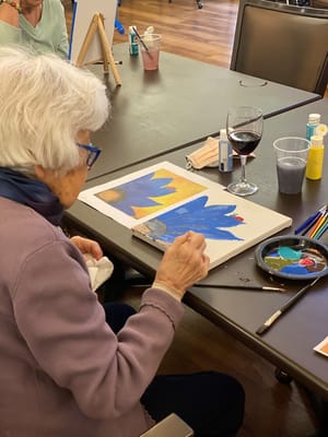 Resident painting in an activity room