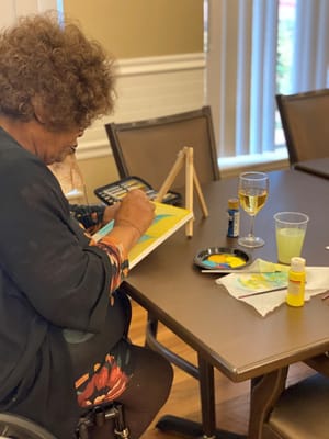 Resident painting in an activity room