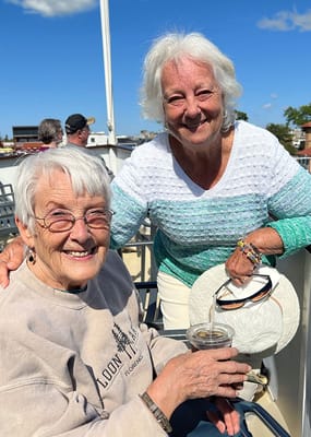 Two residents enjoying time outdoors on a boat