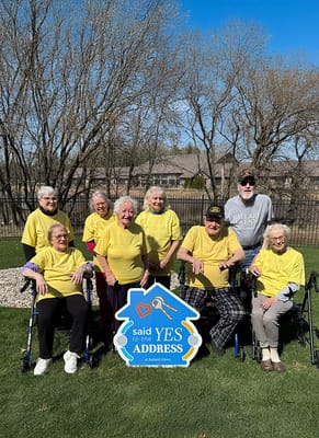 Residents in yellow shirts participating in an outdoor activity