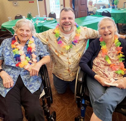 Residents enjoying a festive gathering with a staff member