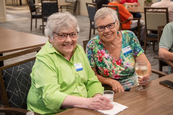 Two smiling residents at a social gathering