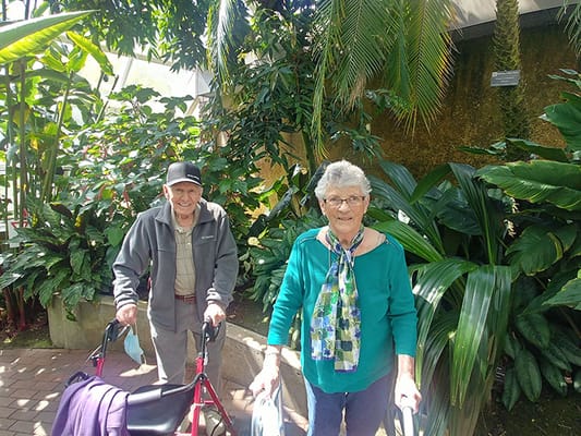 Two residents enjoying the outdoor garden area