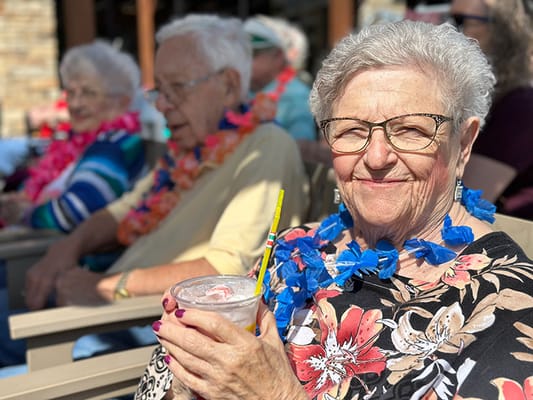 Residents enjoying a festive outdoor activity with drinks
