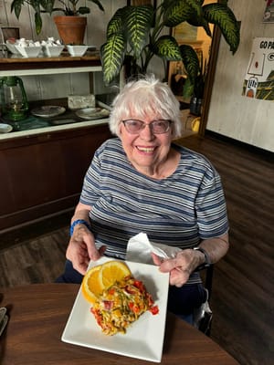 Resident enjoying a meal with a smile