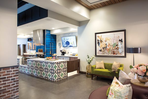 Bright common area with a kitchen and lounge seating