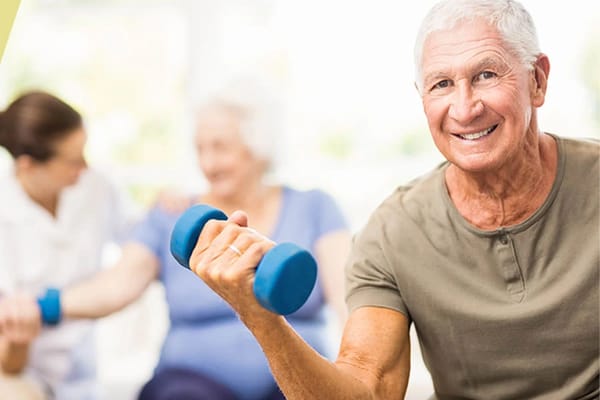 Senior man exercising with weights in a wellness activity
