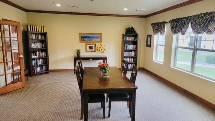 Cozy common area with a table and bookshelves
