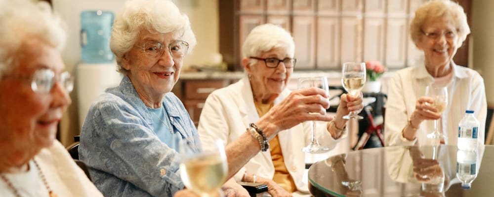 Residents toasting with drinks in a common area