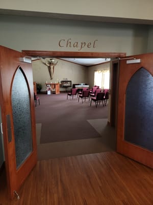 View into a chapel with empty chairs and altar