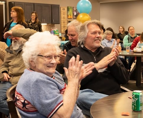 Residents clapping during a lively indoor activity