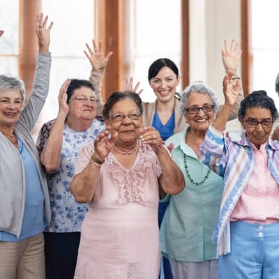Residents and staff celebrating with raised hands
