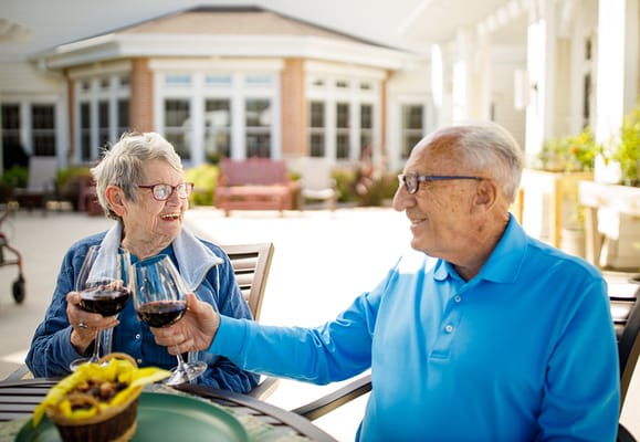 Two residents enjoying wine in an outdoor space