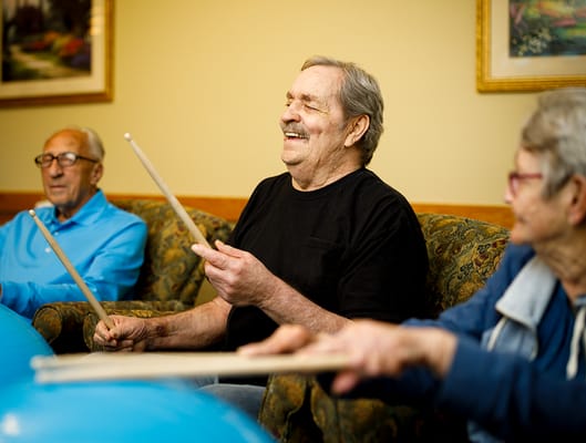 Residents participating in a drum circle activity