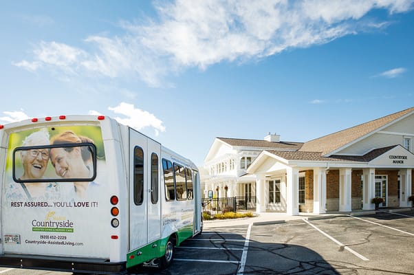 Facility exterior with vehicle visible in parking lot