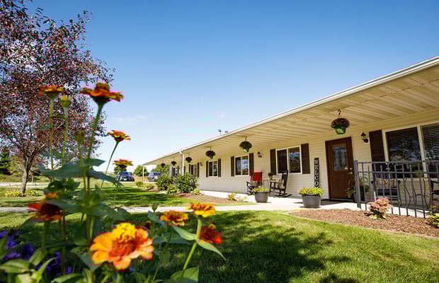 Exterior view of Country Side Manor West with flowers