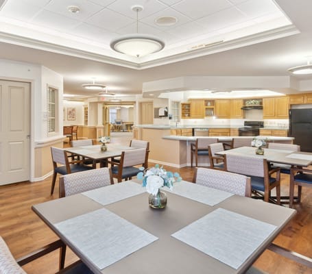 Bright dining room with tables set for meals