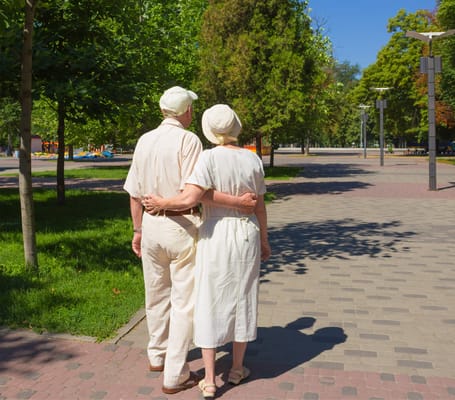 Elderly couple walking together in a park