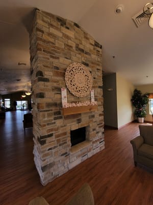 Interior view of a cozy common area with stone fireplace