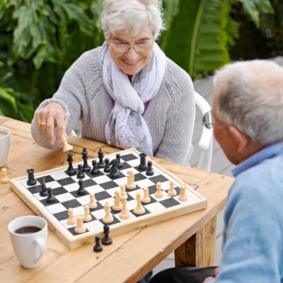 Residents enjoying a game of chess in a garden